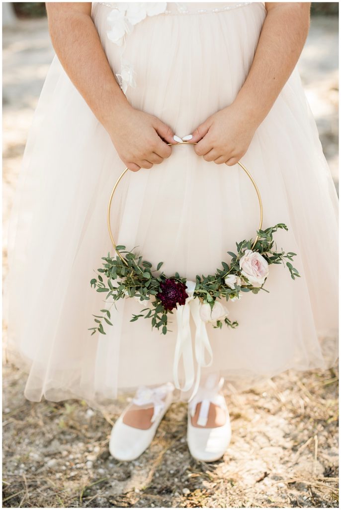 flower girl with hoop bouquet